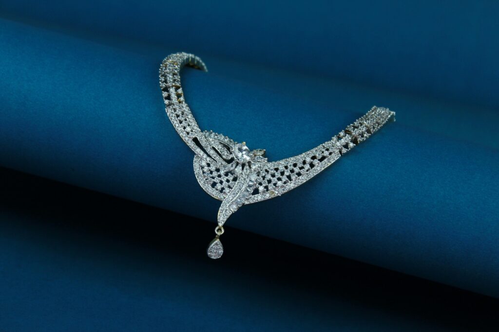 Close-up of a luxury diamond necklace on a deep blue background.