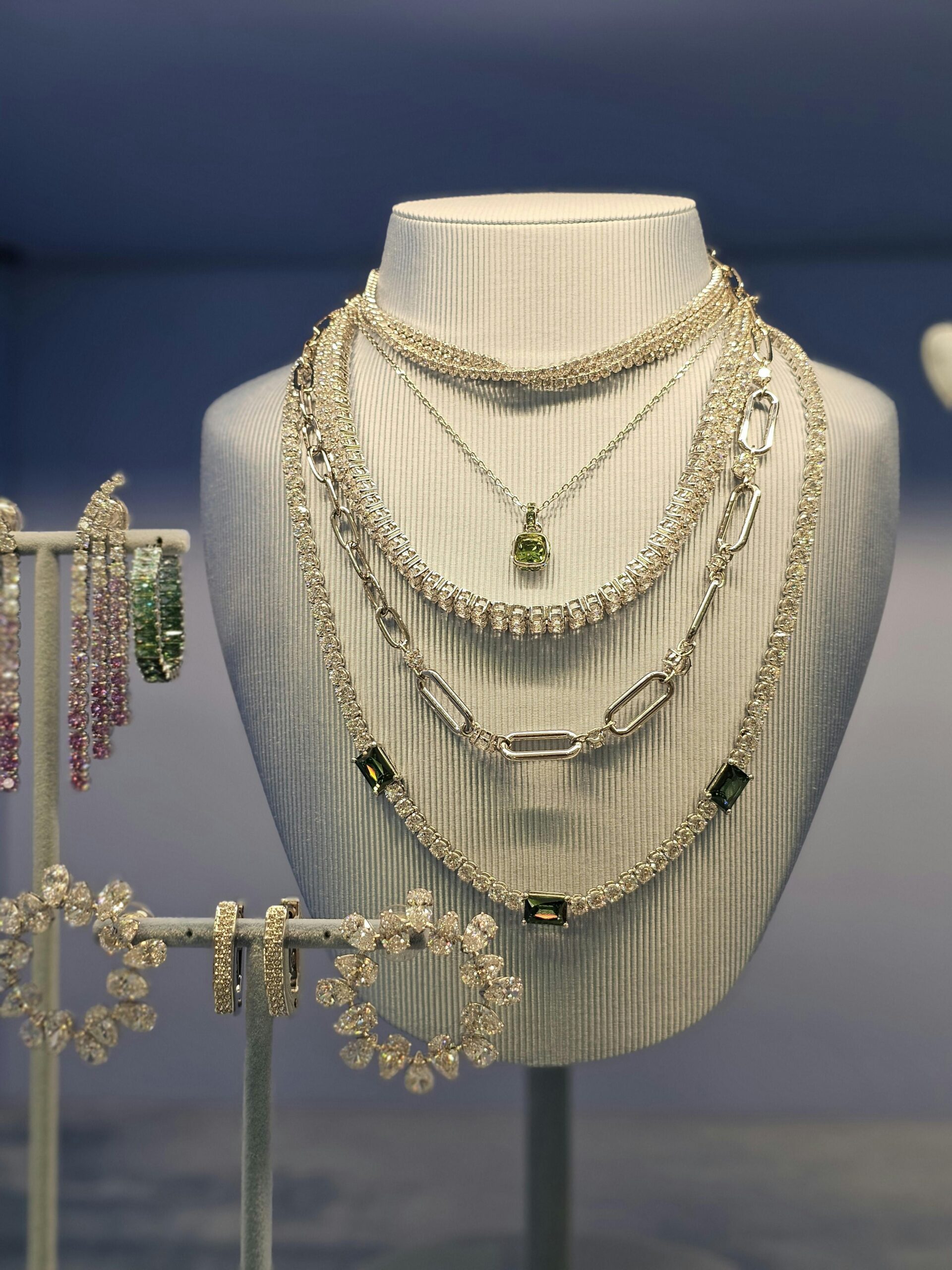 Luxurious necklaces showcased on a white mannequin bust, perfect for highlighting elegance and style.